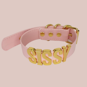 Showing our Sissy collar/choker made with a thick pink PVC collar, gold lettering and fixings.
