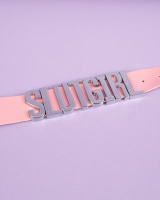 A picture of the slut girl collar in pink laid out flat.