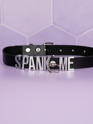 The black Slimline Choker with Spank Me in Silver Lettering.