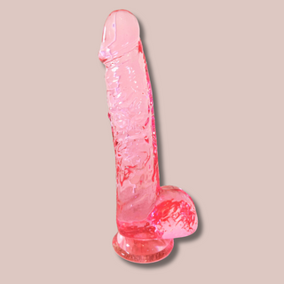 The Pink straight Jelly Dildo shown with the base fixed to the floor.