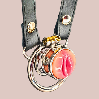 An angled view of The Pussy Ring chastity cage you can just see the barbed ring behind the cage and you can see the belt attached to the base ring ears.