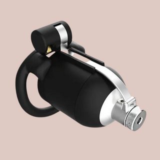 A close up view of The Tusk chastity cage from House Of Chastity, it is shown here fully assembled with the catheter and grub screw in place.