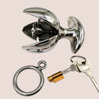 The Blossoming Dilator from House of Chastity shown on its side with its petals unfurled, the handle, lock and keys are also in the picture.