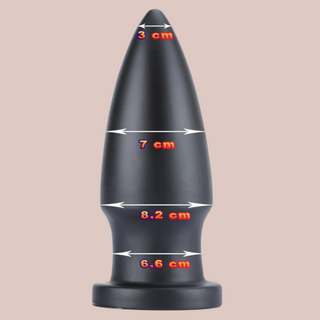 The supersized anal butt plug, shown with the differing width measurements, measuring from 3 cm at the narrowest part to 8.2 cm at the widest part.
