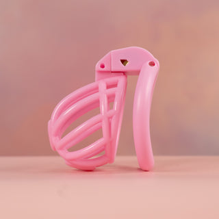 A side view of the fully assembled chastity cage in pink
