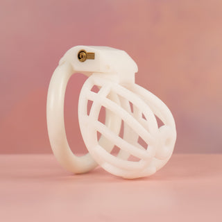An angled view of the fully assembled Cobra Prince Albert chastity cage in white.