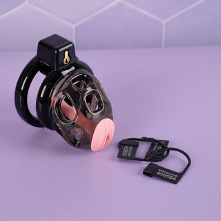 The Custodian chastity cage shown fully assembled, with the urethral tube in place and three keyholder tags.