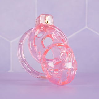 The glass-like pink chastity cage, you can see the transparency and delicate colouring.