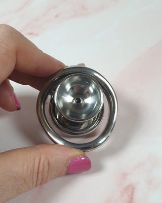 A rear view of the chastity cage, you can see the urethral cup from this angle.