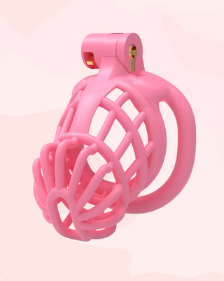 The Jurassic Chastity Cage in pink, the cage is fully assembled with the integral lock in place.