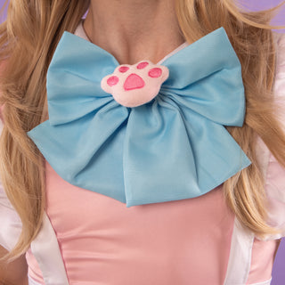 A close up of the large bow and paw print brooch.