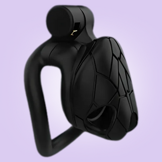 The Python V8 in nano size, this chastity cage is fully assembled with its integral padlock in place.
The face of the cage has an intricate pattern engraved on it that gives the cage the look of a python head.