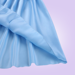 A close up of the skirt, the soft satin feel material has a delicate edging.