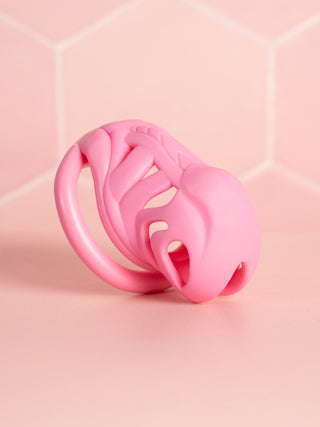 An angled view of the pink chastity cage fully assembled.