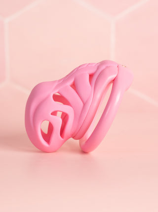 A side view of the chastity device, from this angle the cut out design for air flow and cleaning can be seen fully.