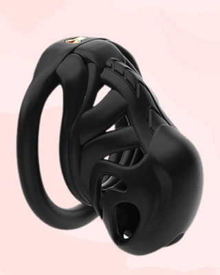 An angled view of the black chastity cage for men, it is shown fully assembled with the base ring and integral lock fixed in place.