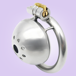 A front on view of the Ultra chastity cage, you can see the centre hole and the patterned circle of holes that surround it to allow air to circulate. From this angle you can see the base ring and how it attaches to the cock cage, along with the integral lock in place.