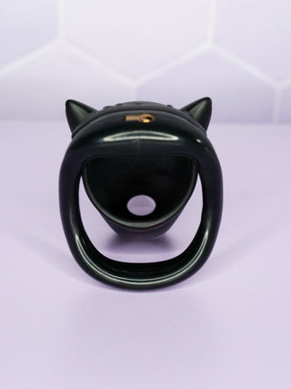 A rear view of the cage, looking through the base ring and into the cage. The mini integral lock can be seen on the top of the chastity cage.