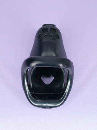 The underside of the chastity cage, the paw print cut out can be seen at the base of the cage. The cut out heart on the neck can also be seen.
