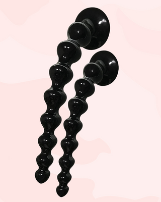 Showing the sucker base being attached to a flat surface, showing that the anal beads can be mounted and then used.