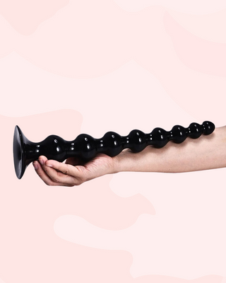 An alternate view of the large super size anal beads against an arm.