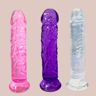 The Translucent Soft Jelly Dildo shown in all 3 colours available, which are pink, purple and clear.