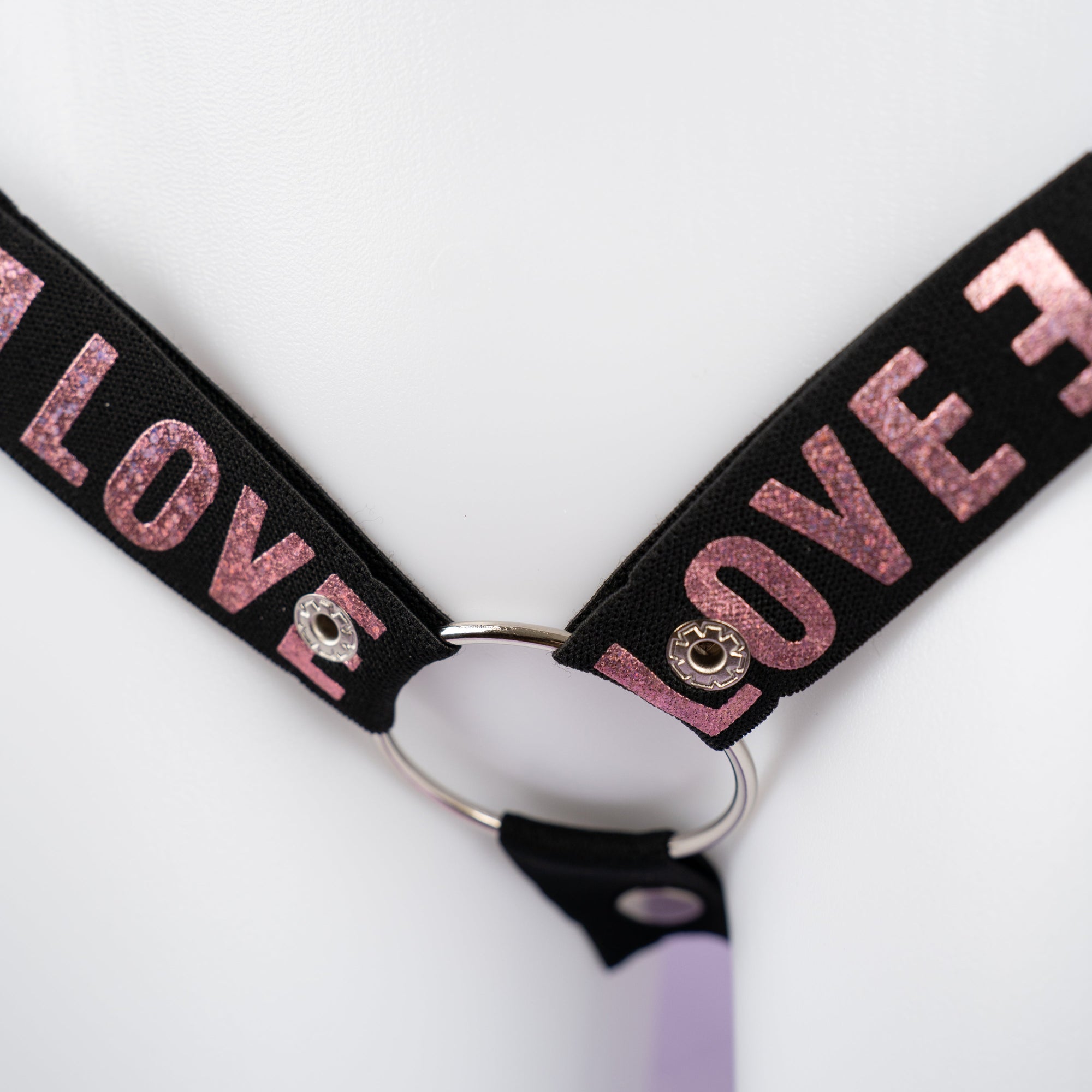 A close up of the shiny pink print on the chastity belt.
