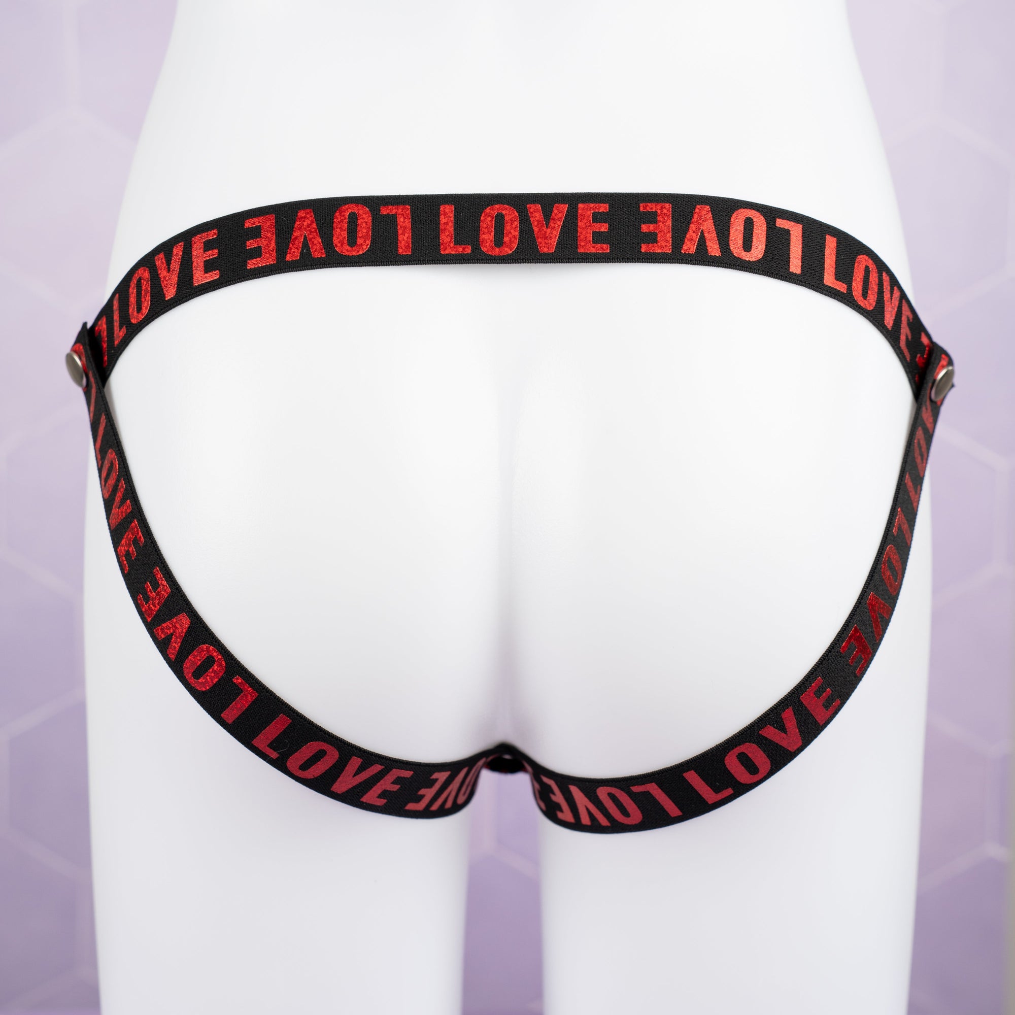 The jock strap style fit of the 3 way restraining chastity belt is shown here, you can see the LOVE print clearly.