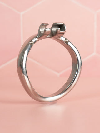 A close up view of the Angled Metal Base Ring, it is designed to be a replacement base ring for chastity cages.