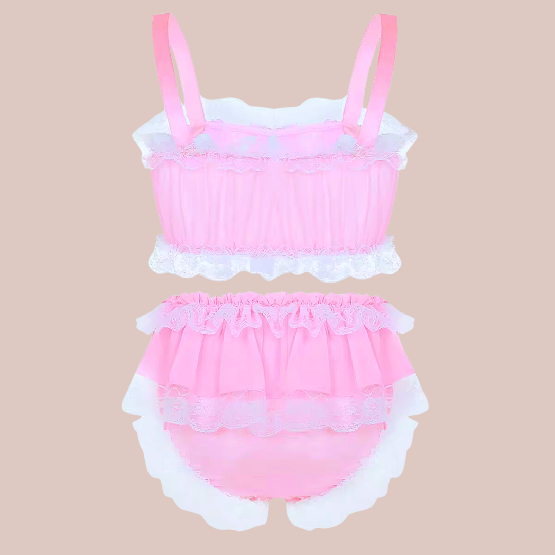 In baby pink, this bra and panties set has bandeau style bra top edged in white lace and colour matching satin bows. The panties are a high waisted design and have matching lace frills and satin bows. 