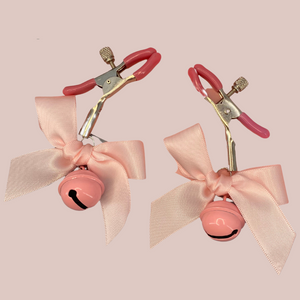 The Bow Bell Nipple Clamps in pink, you can see that the bell, bow and clamp rubbers are all pink.