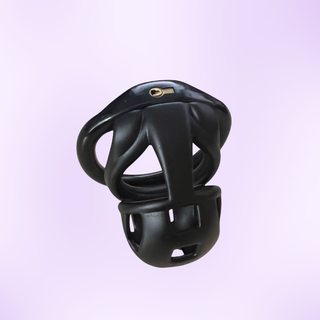 An angled view of the black Nano chastity cage, shown on a purple background