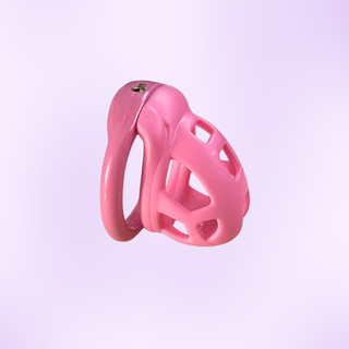 An angled view of the pink chastity cage, it is shown on a purple background