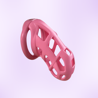 The standard size chastity cage from a side view and shown on a purple background