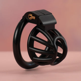 The Cobra Nub chastity device in black, this is an angled close up of the cage, the design allows for air low and urination.