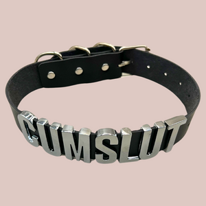 An above view of the Cumslut collar, you can see the lettering and the buckle.