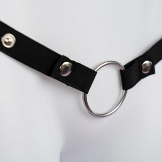 Close up of the black elasticated chastity belt showing ring and adjustable size options.