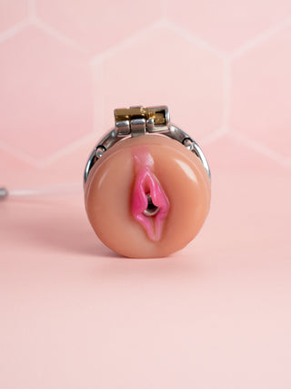 A close up of the fully assembled Flat Gatling chastity cage with the pussy attached to the front.