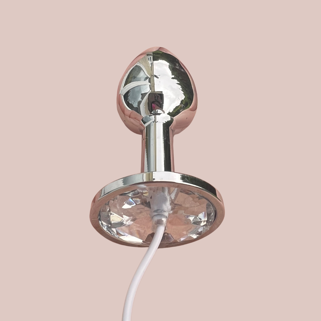 A close up of the white jewelled butt plug