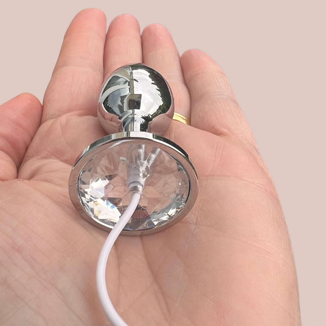 The Jewelled butt plug shown being held to provide an idea of size.