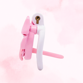 A side view of the pink and white chastity cage, it is shown fully assembled and with the urethral tube fitted