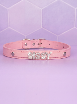 The Glimmer Sissy Collar in pale pink on a purple background