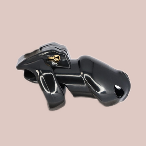 Shown is the black standard cock cage that we offer in our version of the Holy Trainer range. It is shown from the side angle so that you have a full view of the assembled chastity cage, the cock cage is shown attached to a base ring and the integral lock is in place, showing how it fits to the body. This product is the black version, these cages also come in pink and clear.