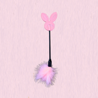 The tickling stick shown on a pink background