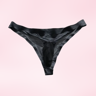 The black Ice Silk G-String shown lying out flat on a pink background