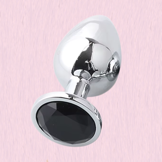 The Jewelled Butt Plug with black base shown on a pink background