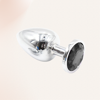 The Jewelled butt plug with black base on a soft pink background