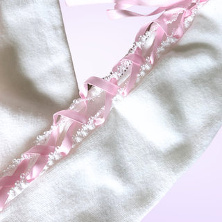 A close up of the pink criss cross lacing