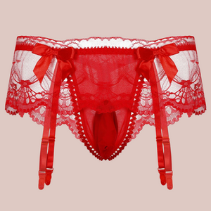 A close up of the red suspender belt and panties set for men, you can see how delicate the lace is and the pretty matching red bows.