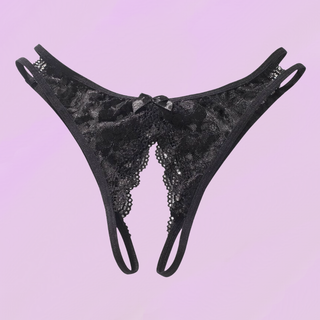 the black crotchless panties lying on a soft purple background